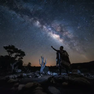 Māori storyteller sharing Tātai Arorangi star knowledge under the Milky Way